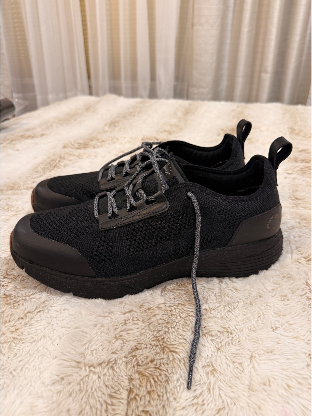 Black lace-up athletic shoes